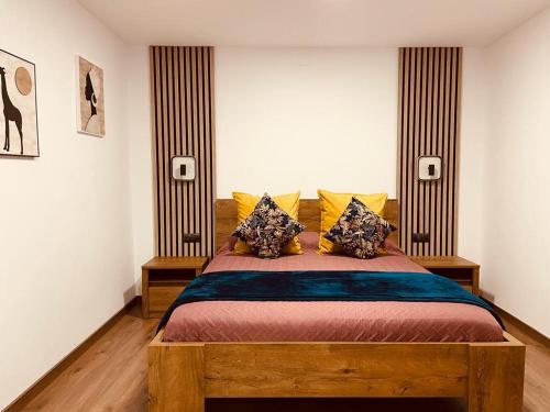 a bedroom with a large wooden bed with pillows at Luxury apartament airport in Málaga