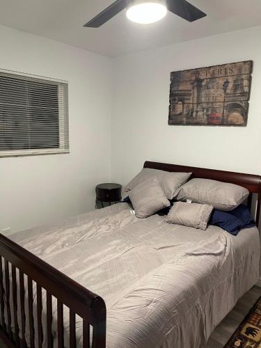 a bed in a bedroom with a ceiling fan at Crazy Horse - APT 1 in Kanab