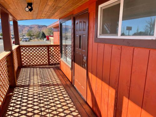 an orange building with a door and a window at Crazy Horse - APT 1 in Kanab