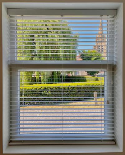 a window with a view of a building at Huyze Ter Vaete in Lo-Reninge