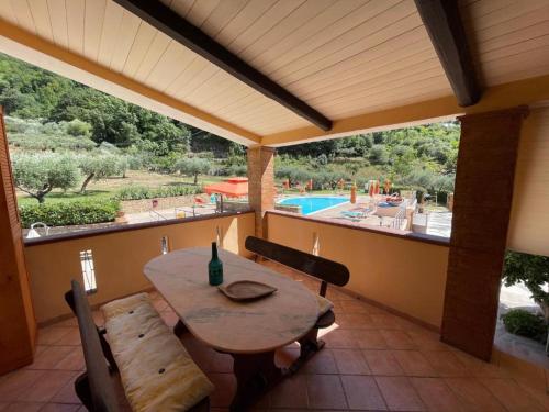 a patio with a table and chairs and a pool at Agri Resort Masusa in Aquara