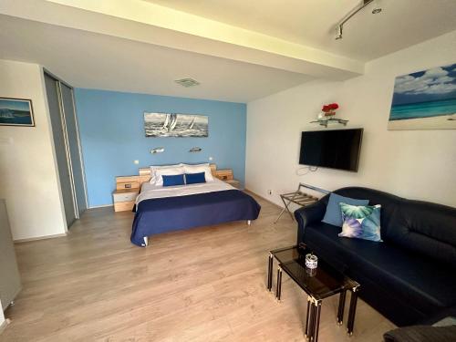 a living room with a bed and a couch at Apartment Stella in Mali Lošinj