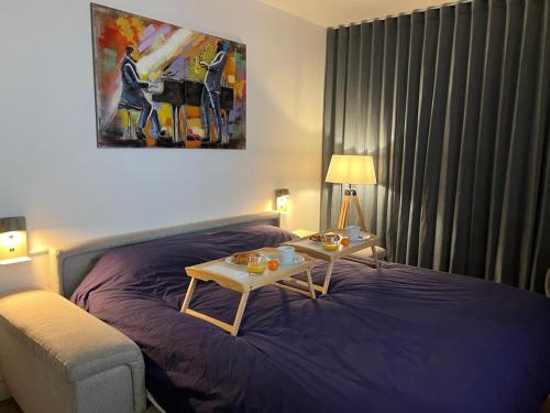 a bedroom with a bed with a table and a couch at Superbe appartement cosy - Plage des minimes in La Rochelle