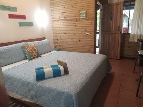 a bedroom with a large bed with pillows on it at Quinta Esencia in Brasilito