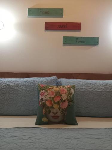 a bed with a pillow with a face on it at Quinta Esencia in Brasilito