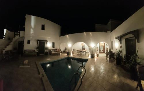 a house with a swimming pool at night at Dar Cristina in Houmt Souk