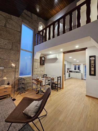 an open living room and dining room with a stone wall at ON THE WAY - Mindelo Beach/Guest House in Mindelo