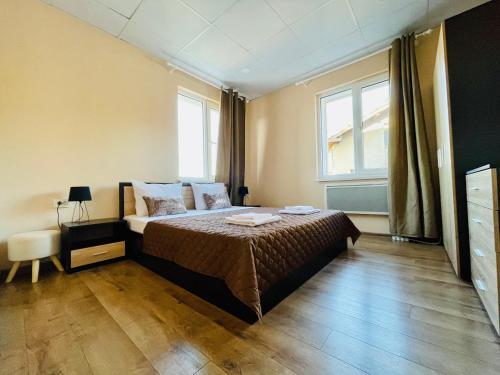 a bedroom with a bed and a large window at Forest Oasis Guest House FREE PARKING in Sapareva Banya