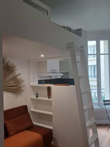 un salon avec un escalier et un canapé dans l'établissement Au pied du Trocadéro, à Paris