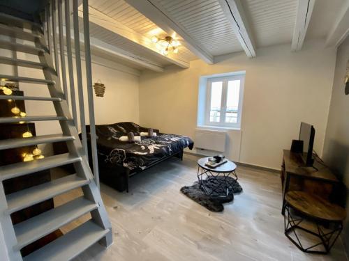 a living room with a staircase and a couch at Le P'tit Rupt Refuge cocooning in Rupt-sur-Moselle