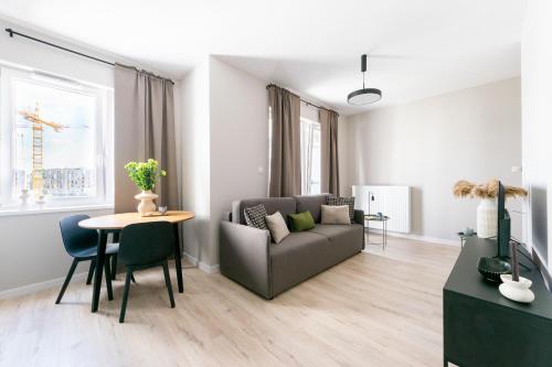 a living room with a couch and a table at Platinum Apartments in Warsaw