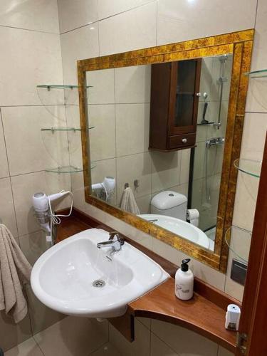 a bathroom with a sink and a mirror at Duplex El Principito in Gran Tarajal