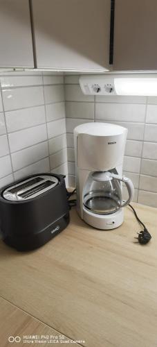 a coffee maker and toaster sitting on a kitchen counter at Cityhome Kaarto in Rovaniemi