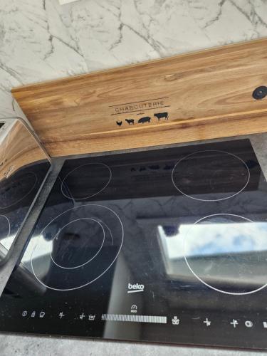 a toaster oven with a wooden top on top of it at Marg's on the Corner in Kumara