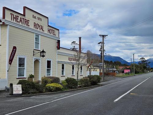 a building on the side of a road next to a street at Marg's on the Corner in Kumara