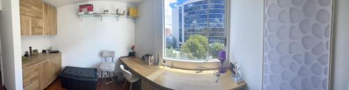 a kitchen with a large window in a room at Acogedor apartamento en zona corporativa Ciudad Salitre in Bogotá