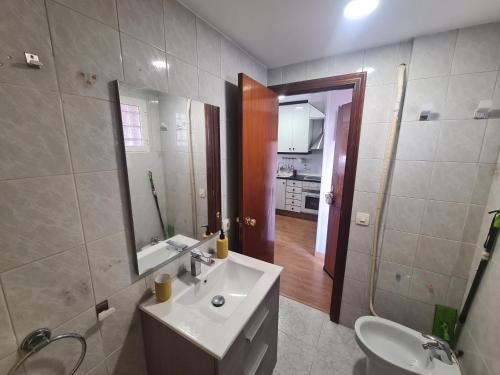 a bathroom with a sink and a toilet and a mirror at Benidorm in Benidorm