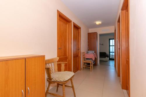 a corridor of a room with chairs and a table at Holiday home Masha in Bogomolje