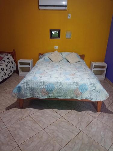 um quarto com uma cama com um edredão em RESIDENCIAL LOS AMIGOS em Puerto Iguazú