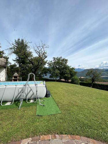 a slide in the grass next to a pool at CA' EDDA APPARTAMENTO GIULIA in Brentonico