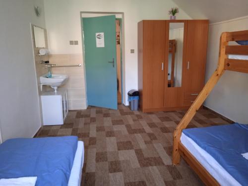 a bedroom with two bunk beds and a sink at Chata Elča in Lipova Lazne