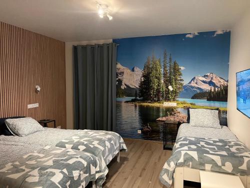 Cama o camas de una habitación en Blue Cottage Bruxelles Sud