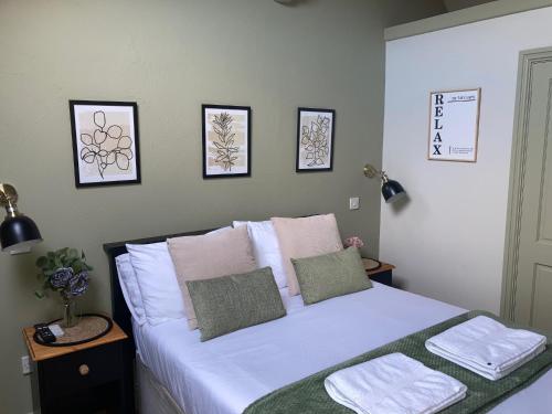 a bedroom with a bed with white sheets and pillows at Blue Ball Inn, Sandygate, Exeter in Exeter