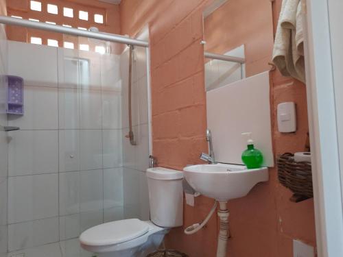 a bathroom with a toilet and a sink at Pousada Alecrim in Aquiraz