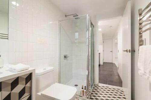 a bathroom with a shower and a toilet and a sink at Central Location Brooklyn Stay at Rem-Casa in Brooklyn