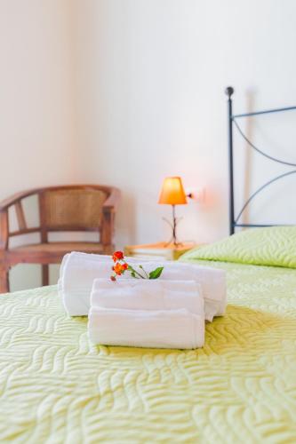two towels are sitting on top of a bed at Residence Fior di Sulcis in Calasetta