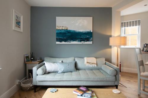 a living room with a couch and a table at Church St. Retreat, Filey in Filey