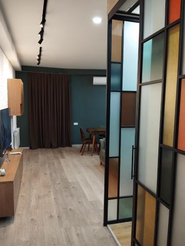 an empty room with a table and a glass door at House number 1 in kutaisi in Kutaisi