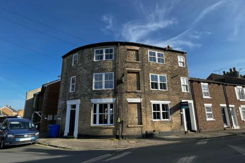 a brick building with a car parked in front of it at Church St. Retreat, Filey in Filey