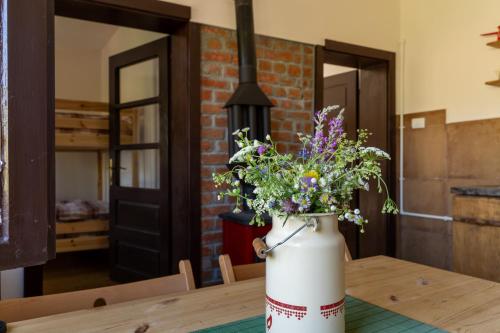 a vase filled with flowers sitting on a table at Mir i planina 