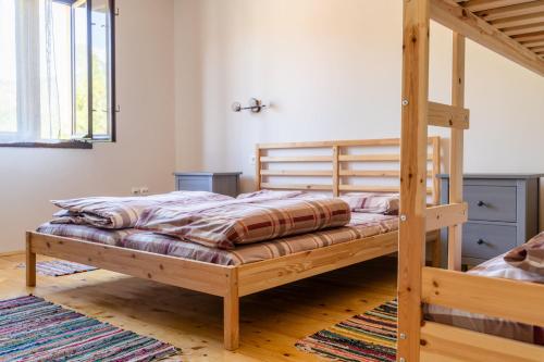 a bedroom with a wooden bunk bed with a ladder at Mir i planina in Bučje