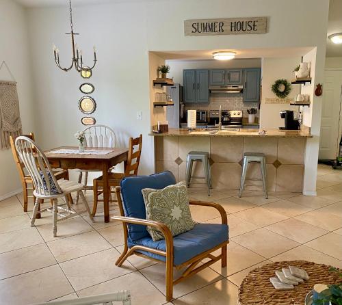 a dining room and kitchen with a table and chairs at Cypress Retreat in Fort Myers