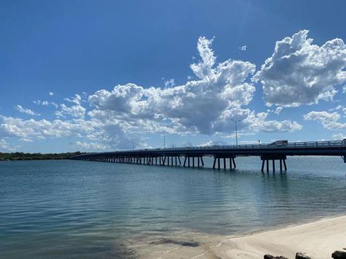 a bridge over the water with a truck on it at Bribie Get away in Bongaree