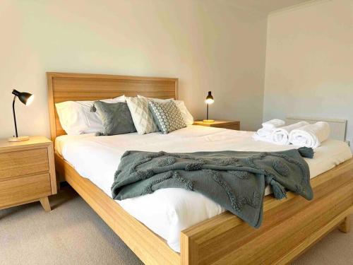 a bedroom with a large bed with white sheets and pillows at Beachfront House - Hot Tub, Ocean Views, Private Beach Pathway in White Beach