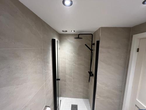 a shower with a glass door in a bathroom at Spacious 2-bedroom holiday apartment - Hemsedal Veslehorn 14 in Hemsedal
