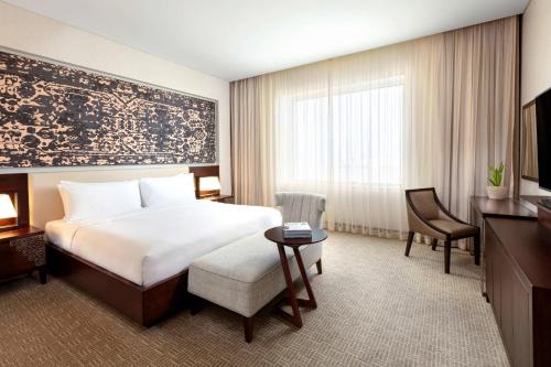a hotel room with a bed and a desk at JW Marriott Hotel Muscat in Muscat