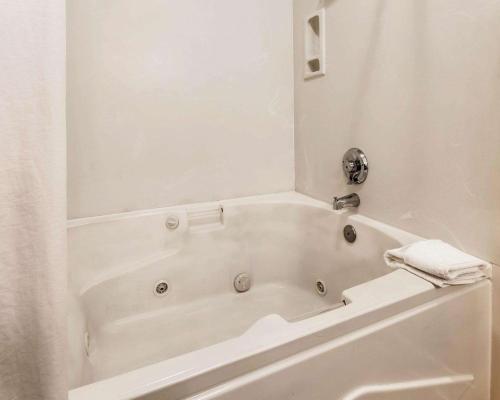 a white bath tub in a bathroom with a towel at Quality Inn Tulalip - Marysville in Marysville