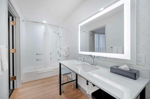 a white bathroom with a sink and a mirror at Comfort Suites Idaho Falls in Idaho Falls