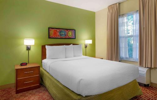 a bedroom with a large white bed and a window at Extended Stay America Suites - Chantilly - Dulles in Chantilly