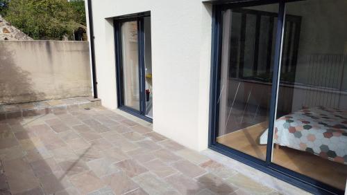 a room with sliding glass doors on the side of a house at Joli appartement proche forêt et centre-ville in Cholet