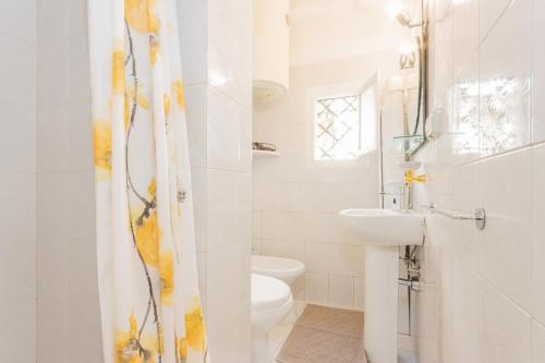 a white bathroom with a sink and a toilet at Extravacanza Central Station 2 in Bari