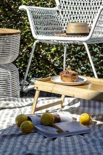 a table with a plate of food and a hat on it at Esplanade Elegance Seaford: Sleeps 7 in Seaford