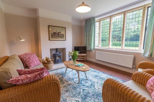 a living room with two couches and a table at 2 The Winnings - Stunning Cottage on a Country Estate in Worksop