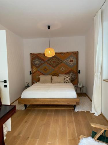 a bedroom with a large bed with a wooden headboard at Liv'In Garden I Boutique Apartment I Szentendre in Szentendre
