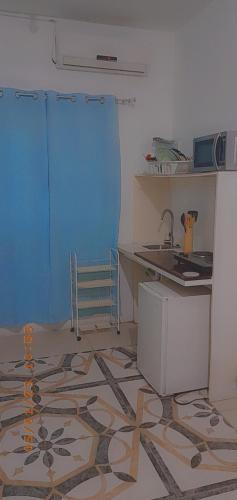 a kitchen with a counter and a sink in a room at Grace Garden Guesthouse by Eminence Ent in Ocho Rios
