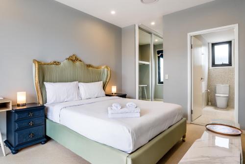 a bedroom with a bed with two towels on it at Westend 3 bedroom Split level Townhouse Next to River in Brisbane